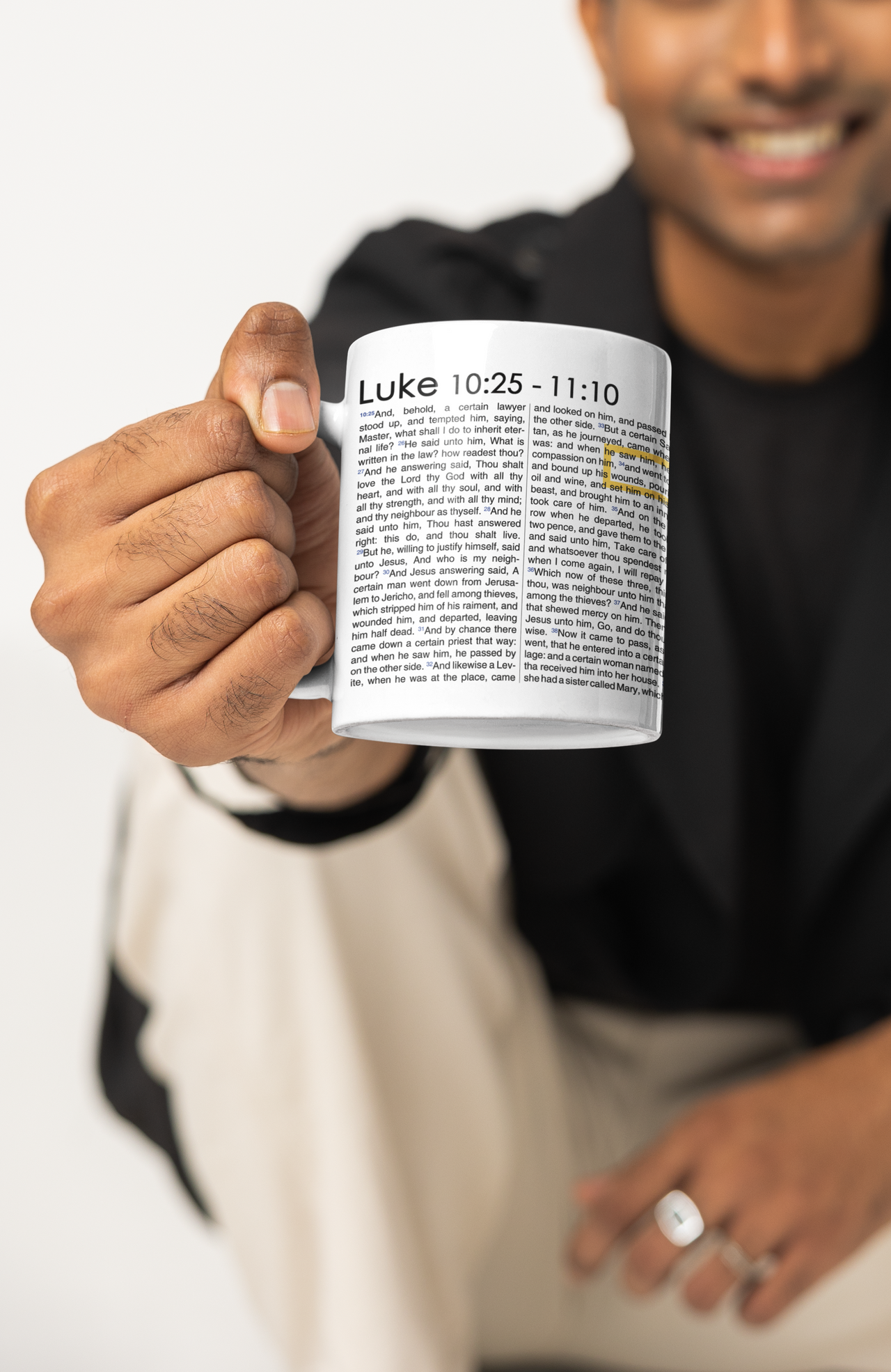 a man holding a coffee mug in his hand