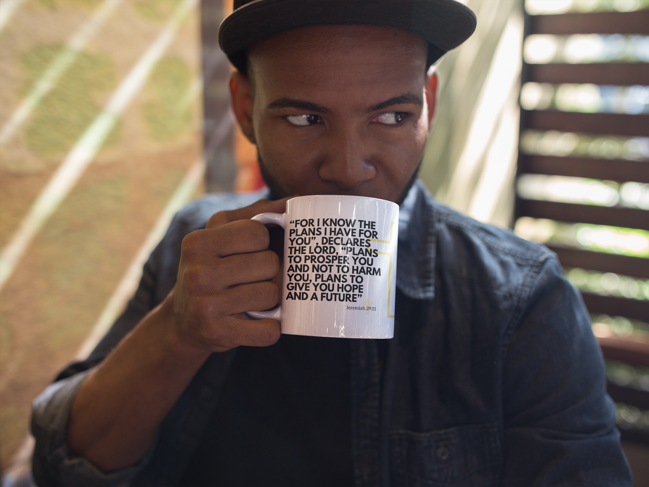 a man holding a coffee mug with a quote on it