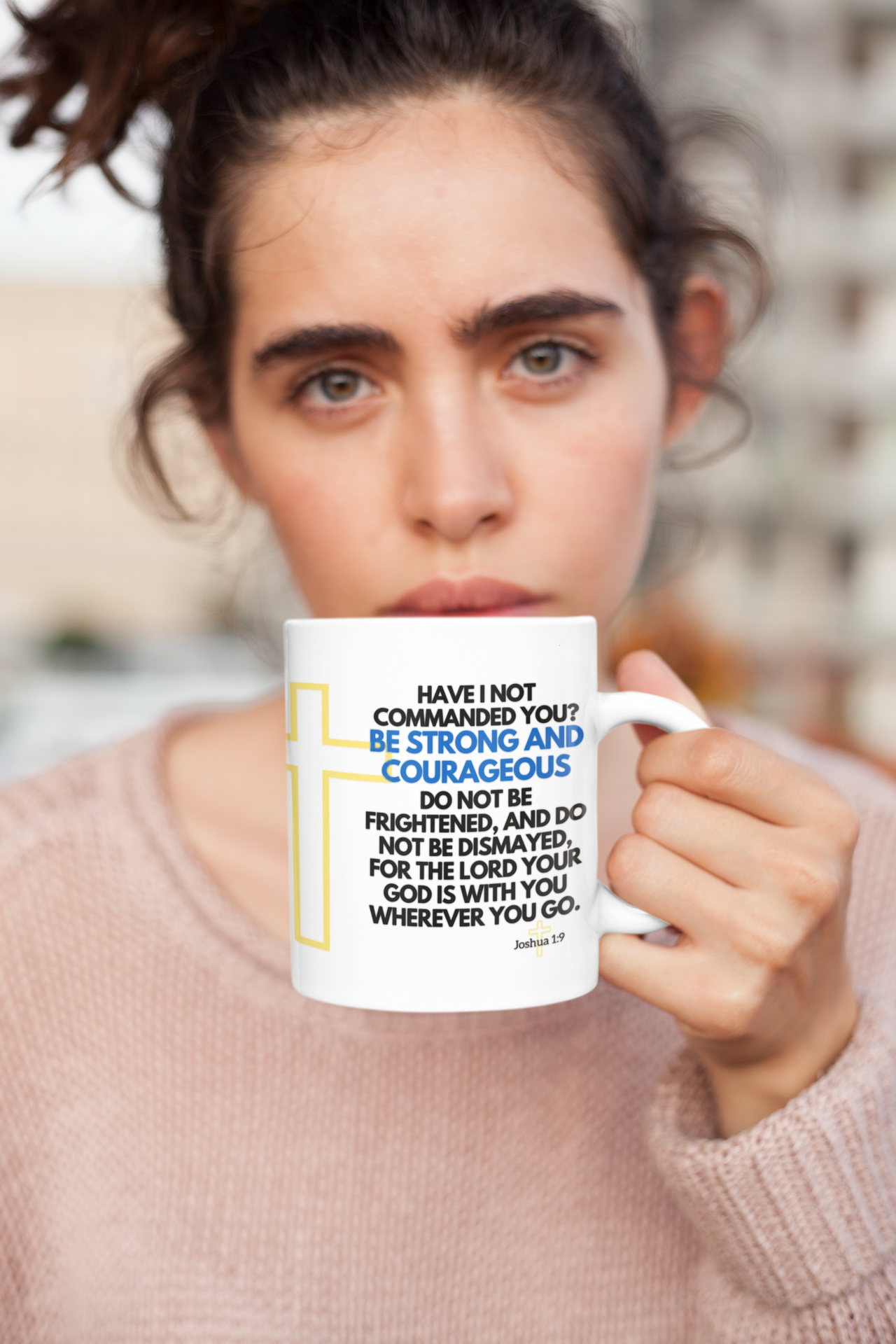 a woman holding a coffee mug with a quote on it