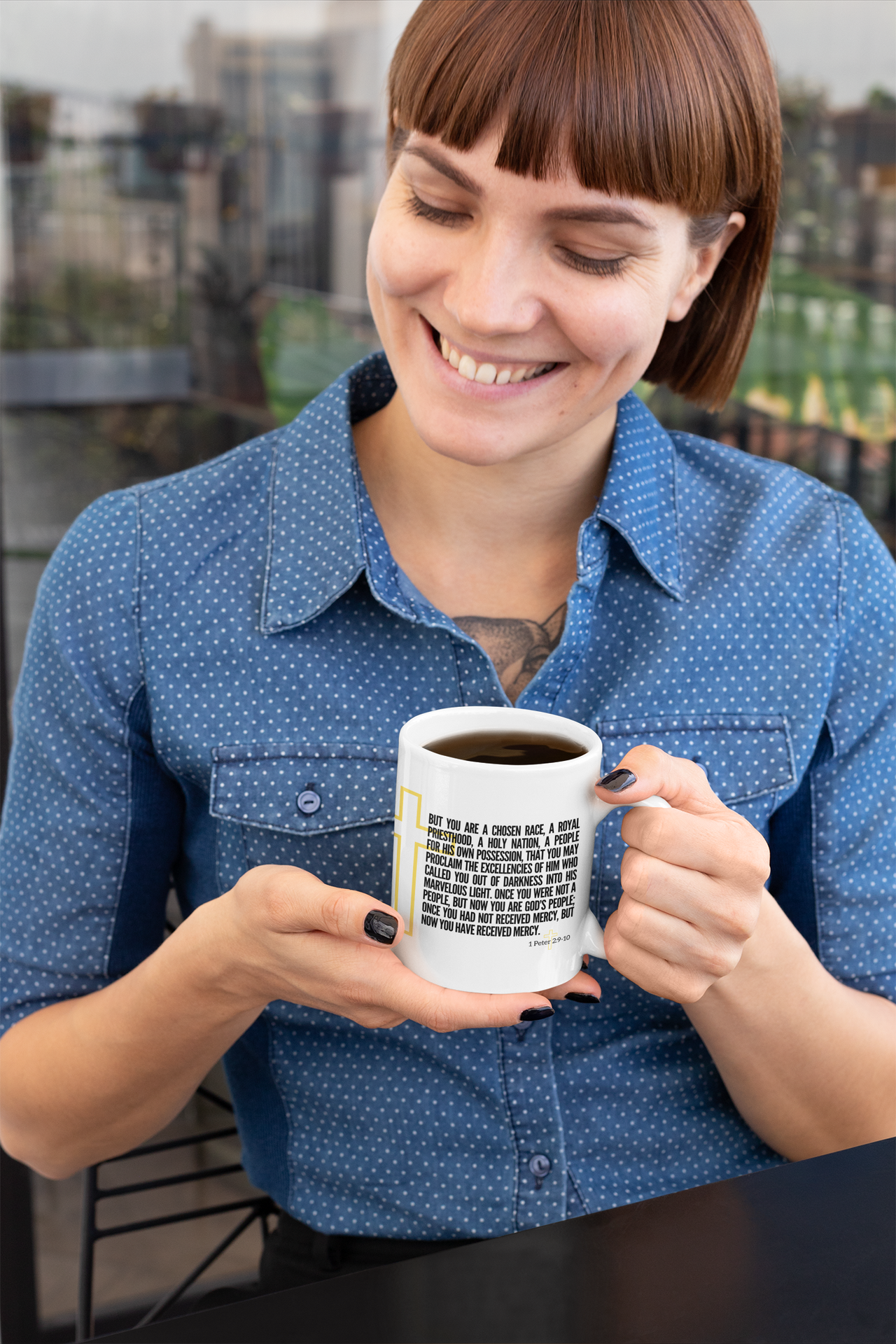 a woman is holding a coffee mug and smiling